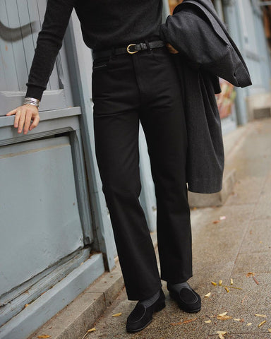 Model wearing mens selvedge jeans by Luxire in black