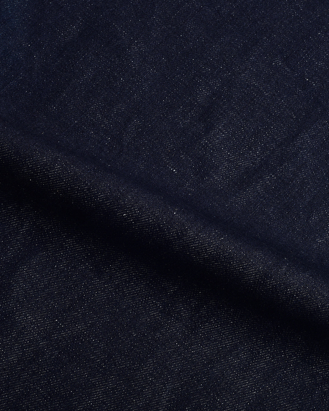 Close up view of custom linen cotton jeans for men by Luxire in indigo 2